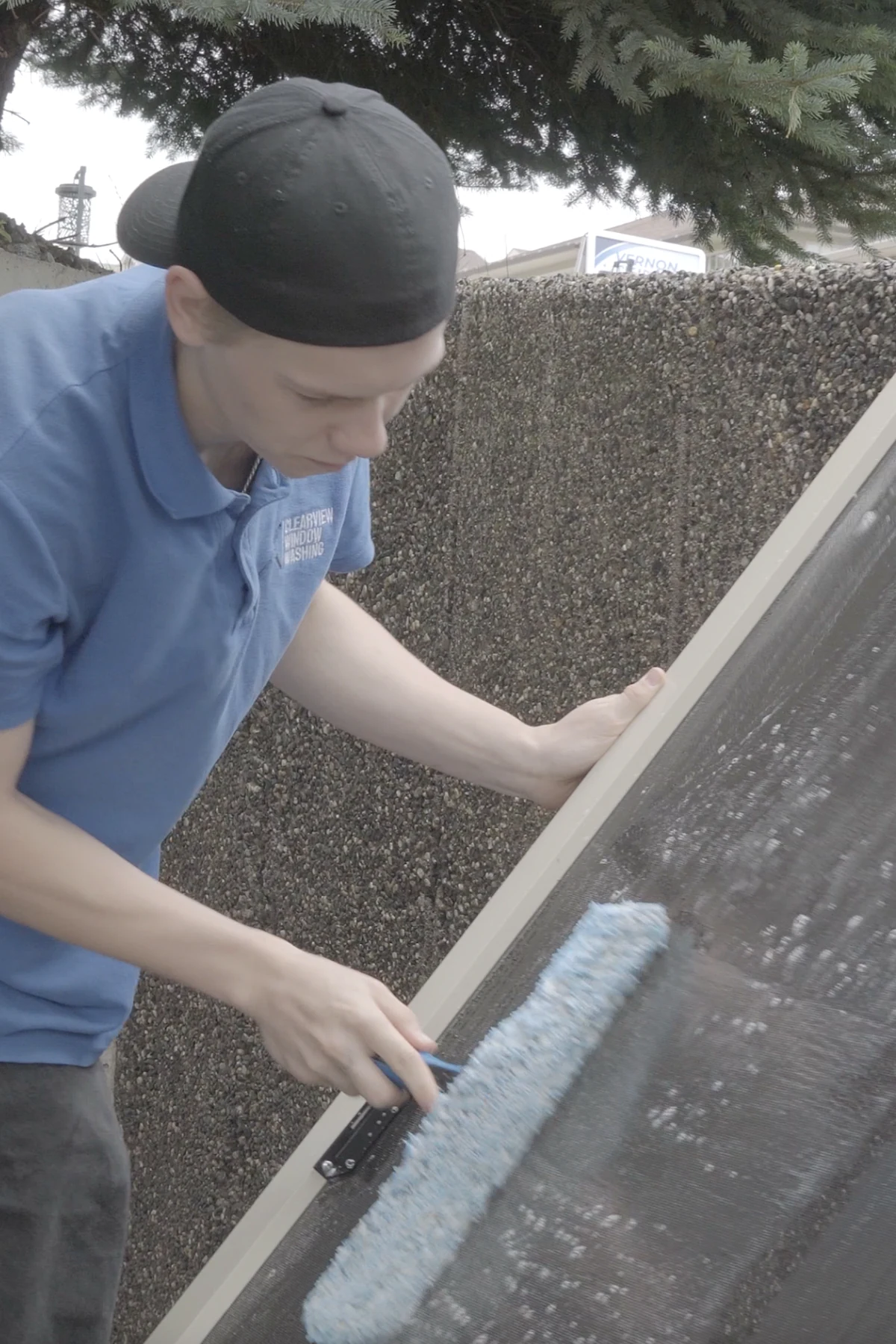 Vernon Clearview worker carefully cleaning a residential window screen